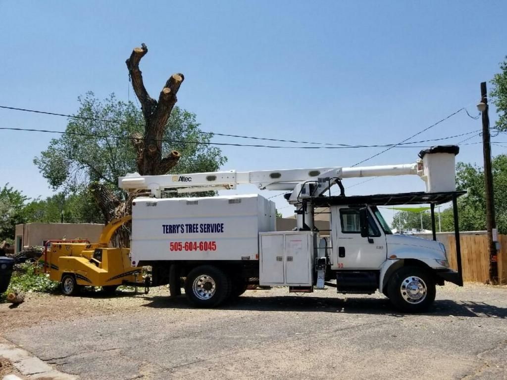 A terry's tree service truck is parked on the side of the road