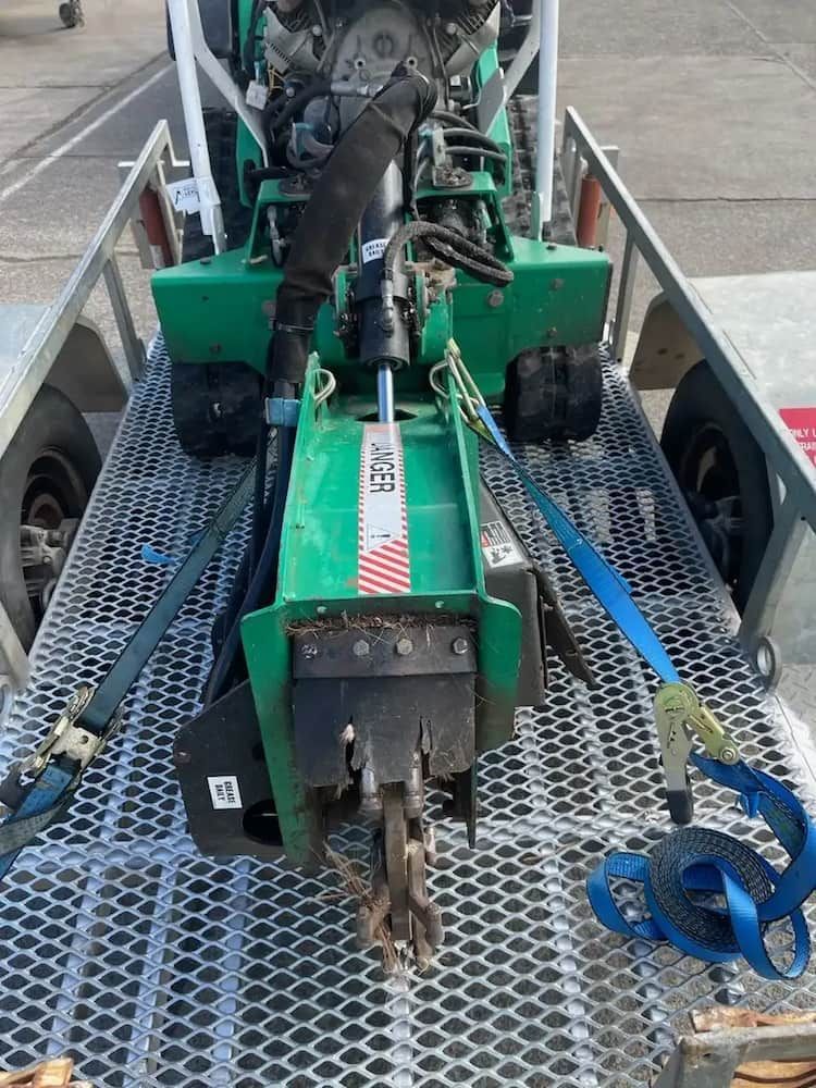 A Green Machine is Sitting on Top of a Trailer — Auz Tree in Hallidays Point, NSW