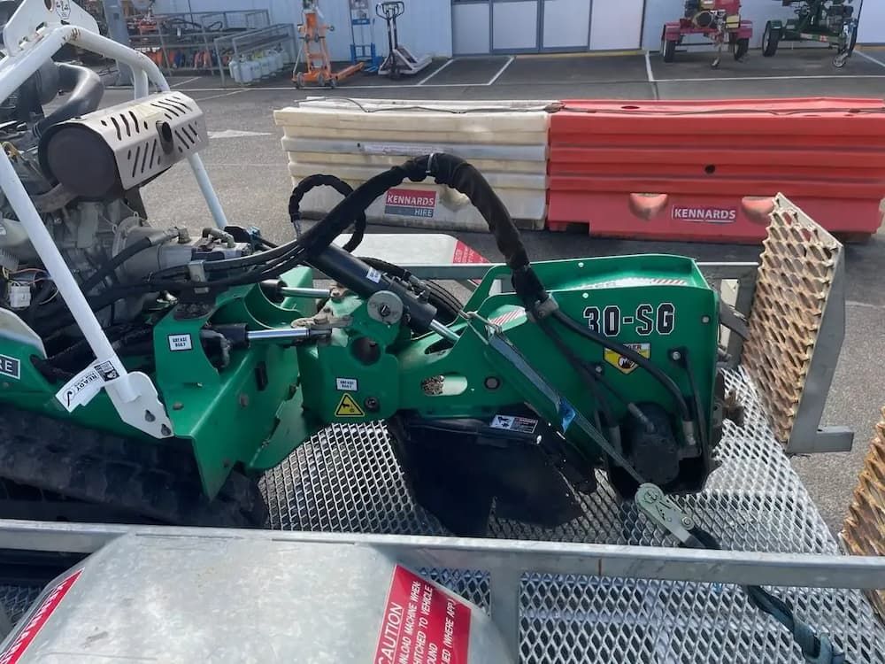 Green 20-SG trench cutter on a trailer, with black hoses and metal frame. — Auz Tree in Hallidays Point, NSW