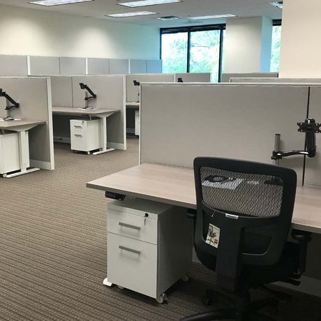 Open work area with desks and cubicle dividers