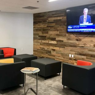Blocky chairs facing a TV in a reception area