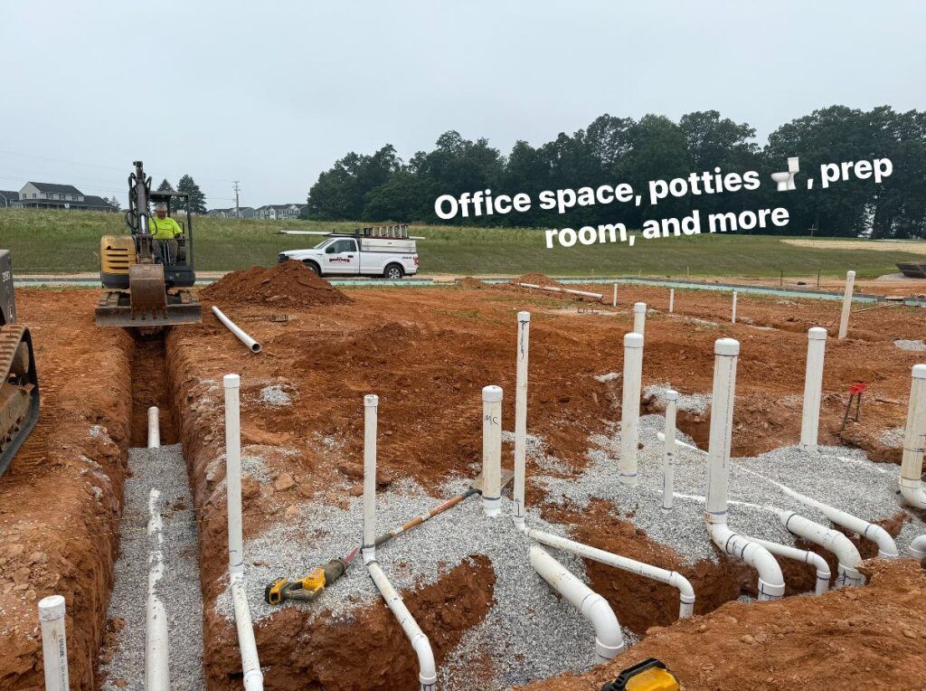 Construction site with buried pipes, an excavator, and a white truck; text overlay:
