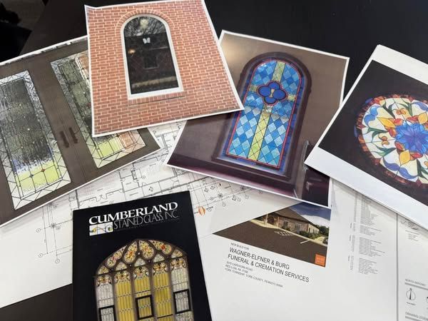 Photos and architectural plans of stained glass windows and building designs.