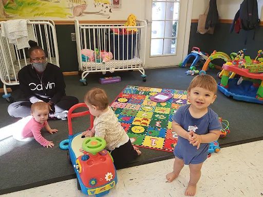 A group of babies are playing with toys in a room.