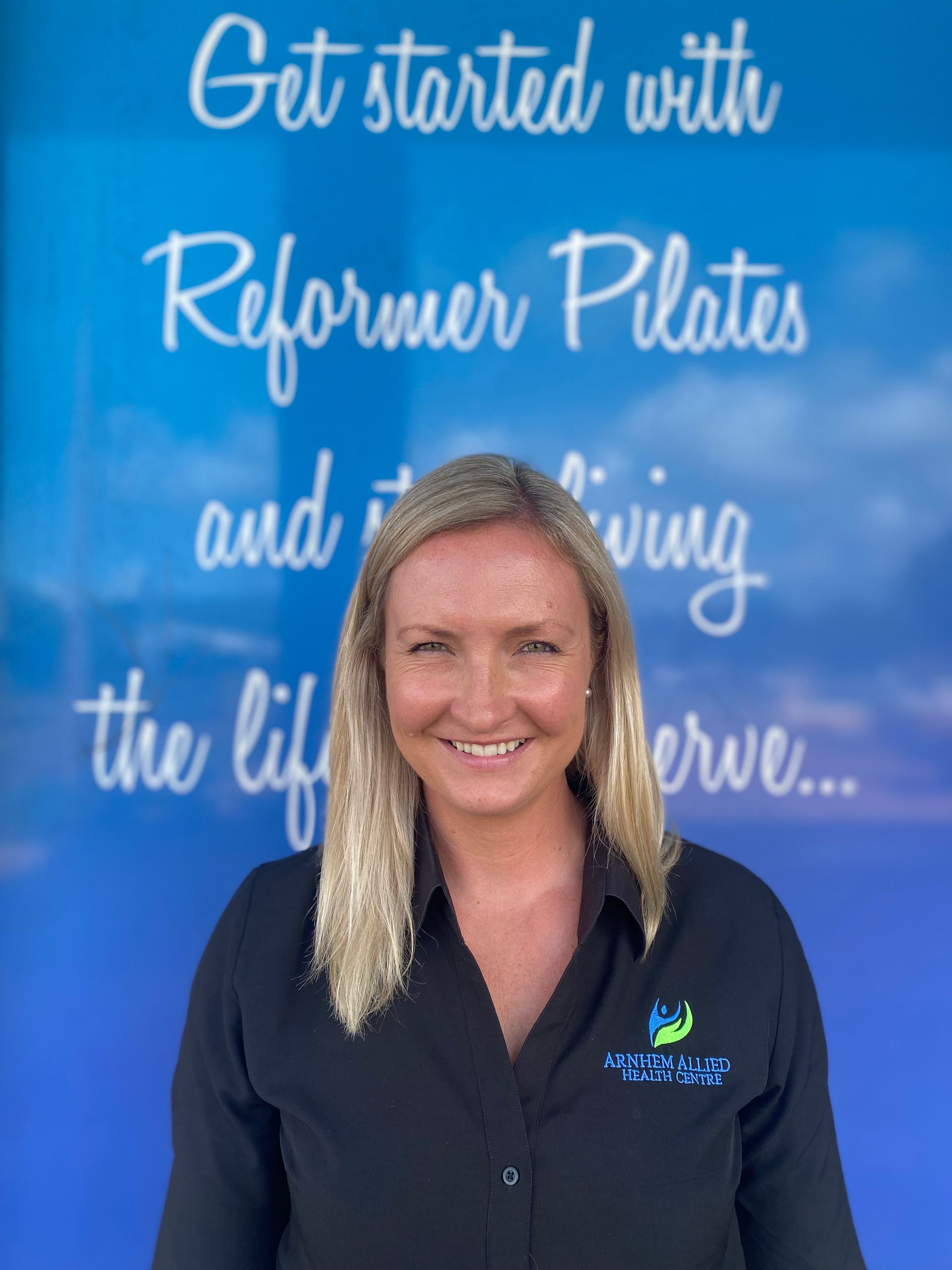 A sandy beach with a small island in the distance