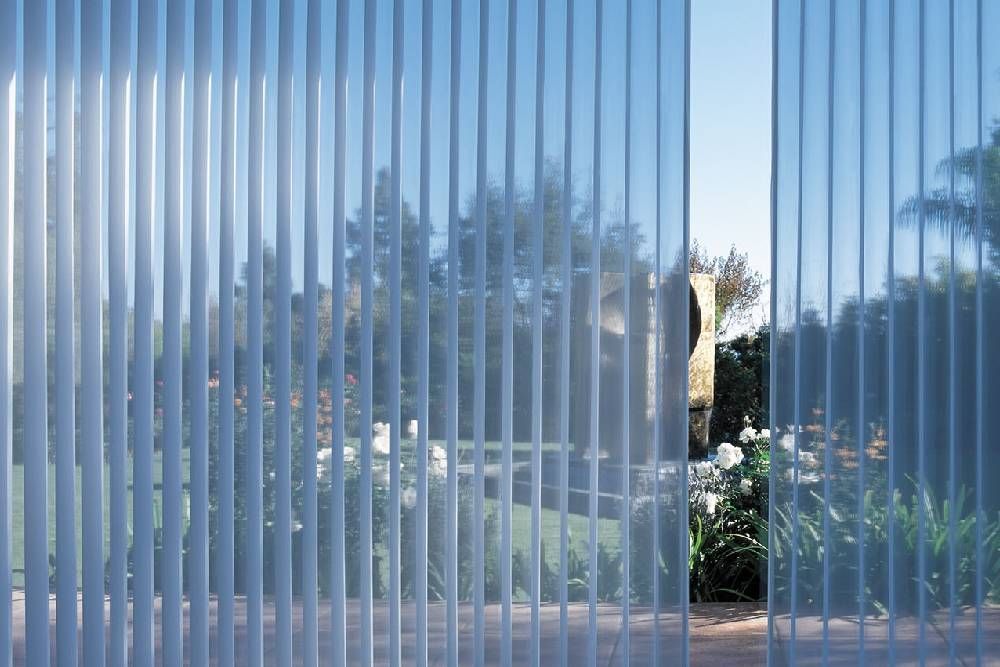 A picture of a window with vertical blinds on it.