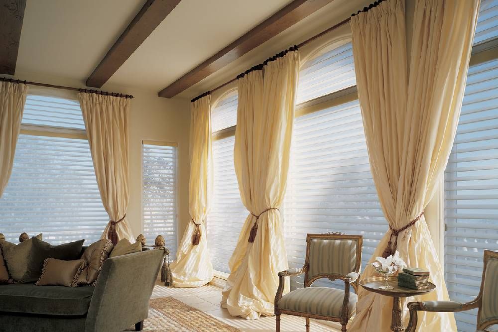 A living room with a lot of windows and custom curtains