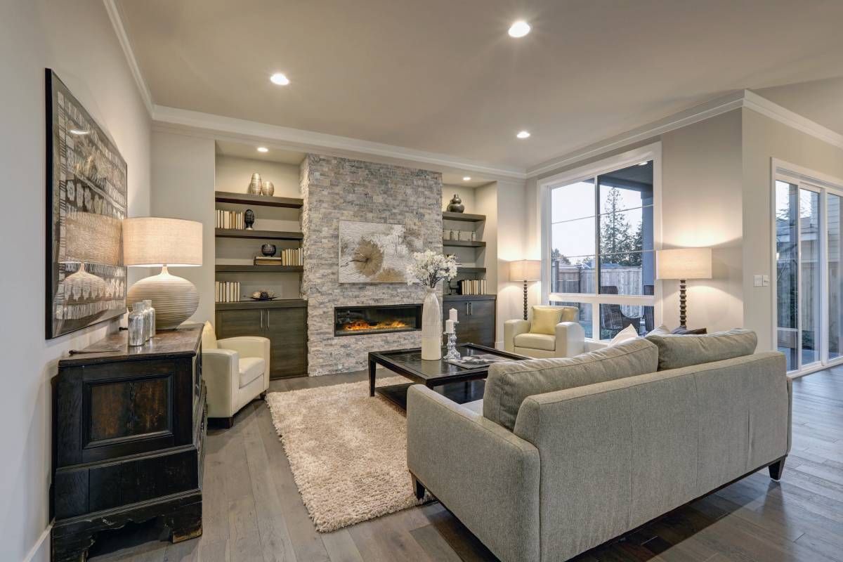 A living room with a couch , chairs , coffee table and Hunter Douglas window