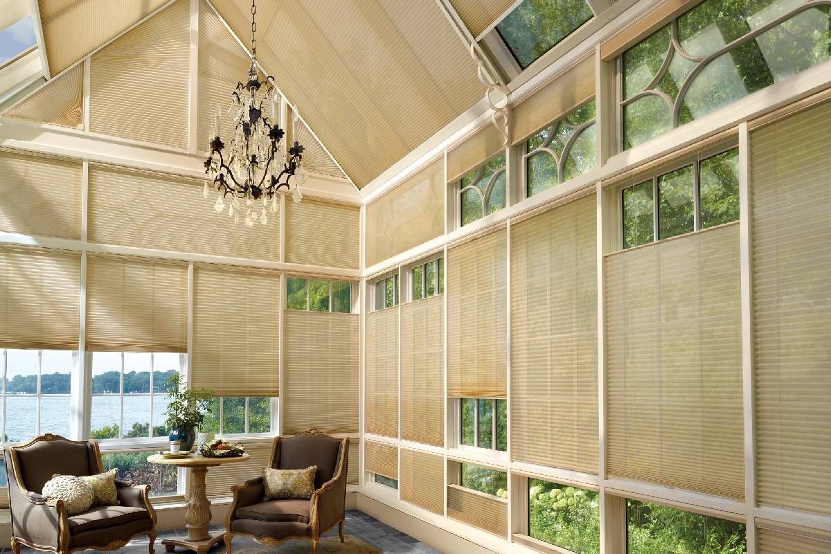 A living room with lots of windows and custom honeycomb shades