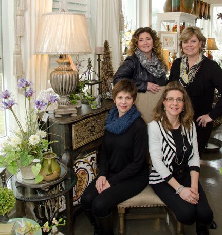 A group of women from Heritage Design are posing for a picture in a living room