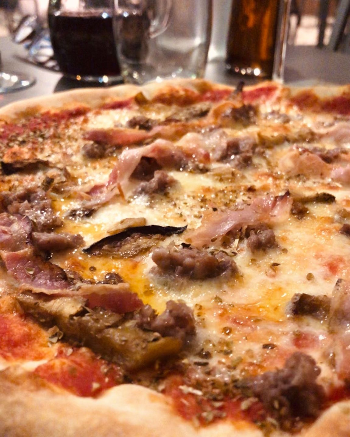 pizza with aubergines, sausage and bacon