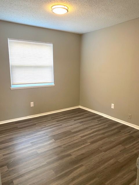 interior apartment bedroom with window and laminate floors