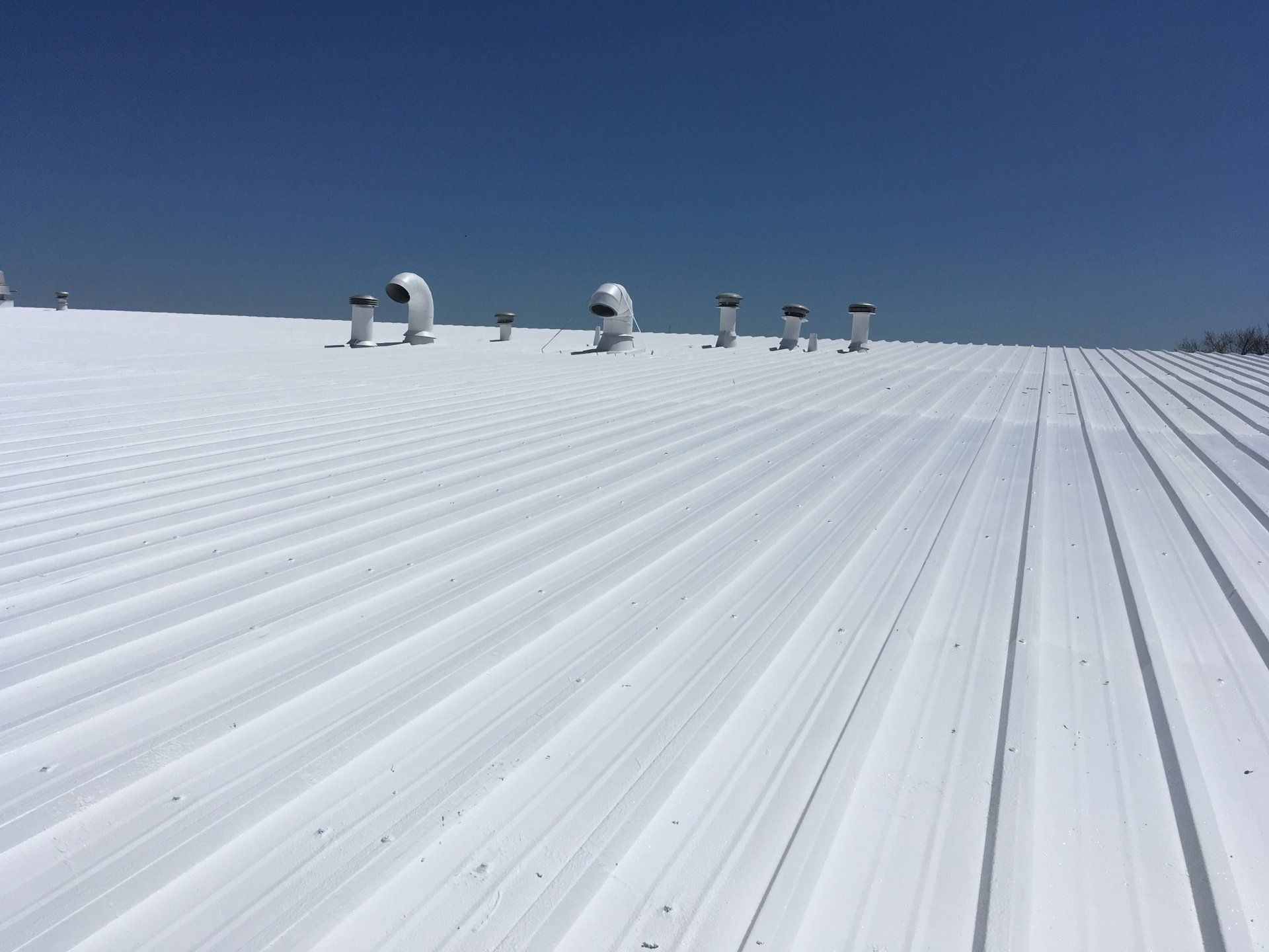 A white roof with a blue sky in the background