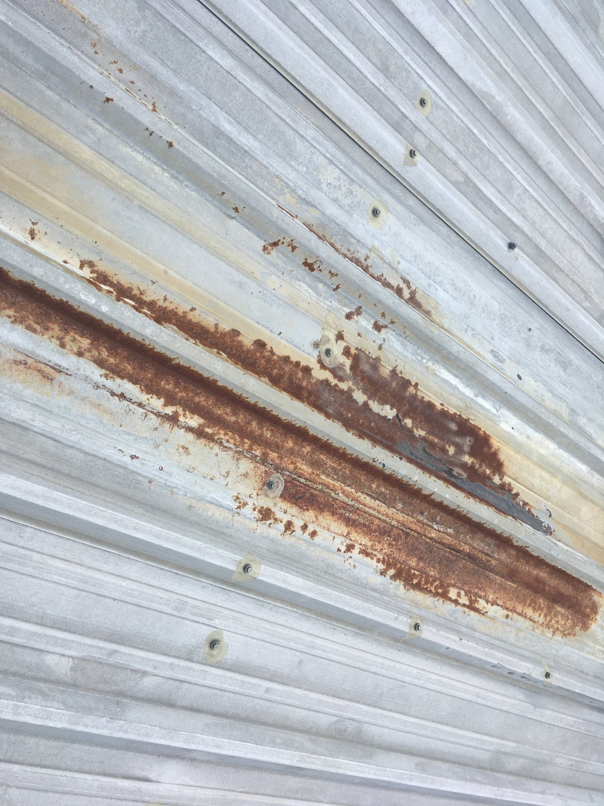 A close up of a rusty metal roof.