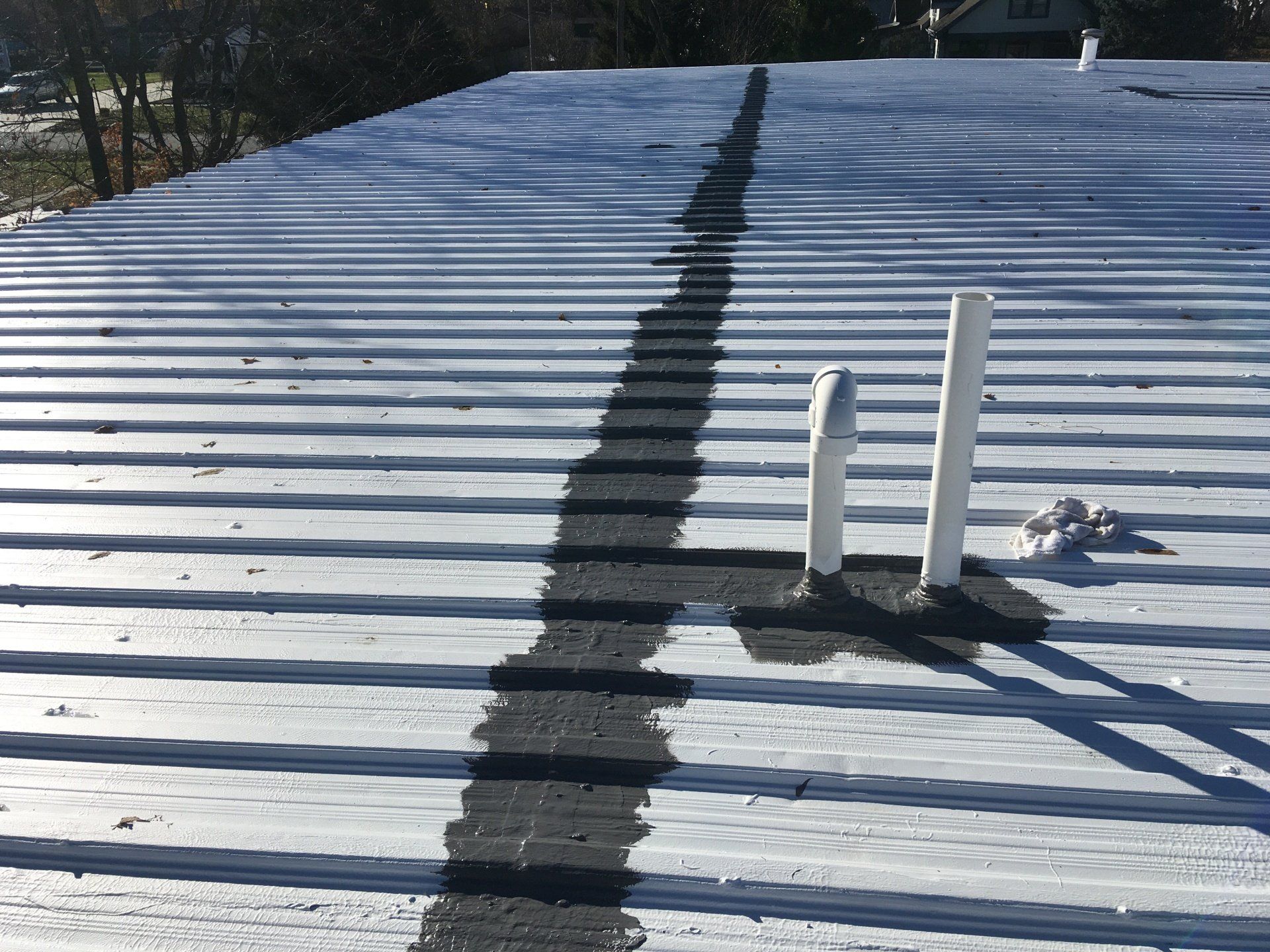 A metal roof that has some repair materials applied.