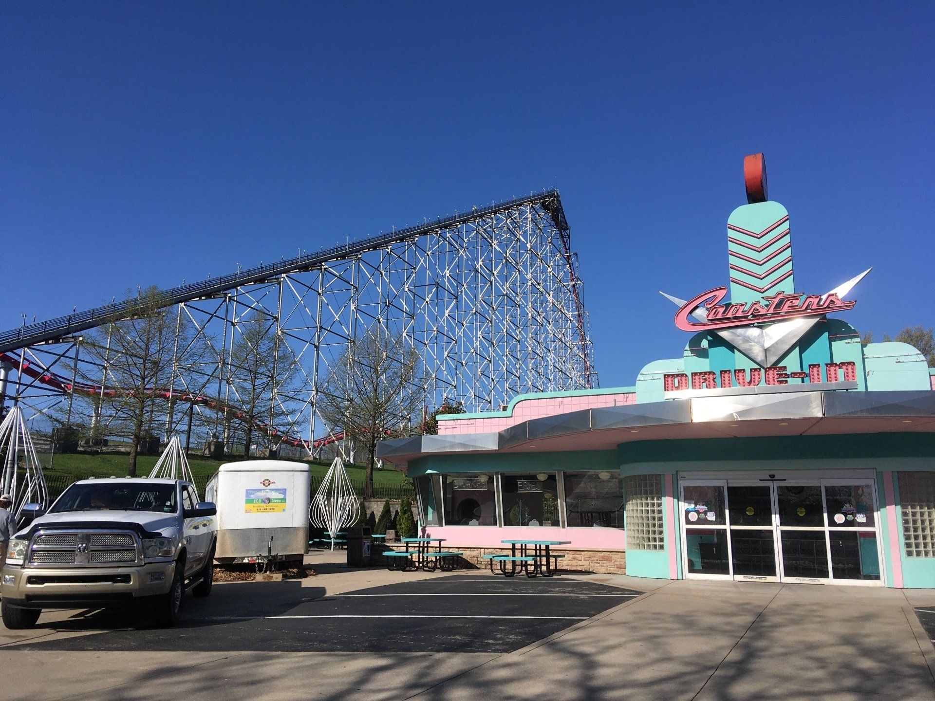 A diner with a roller coaster in the background.