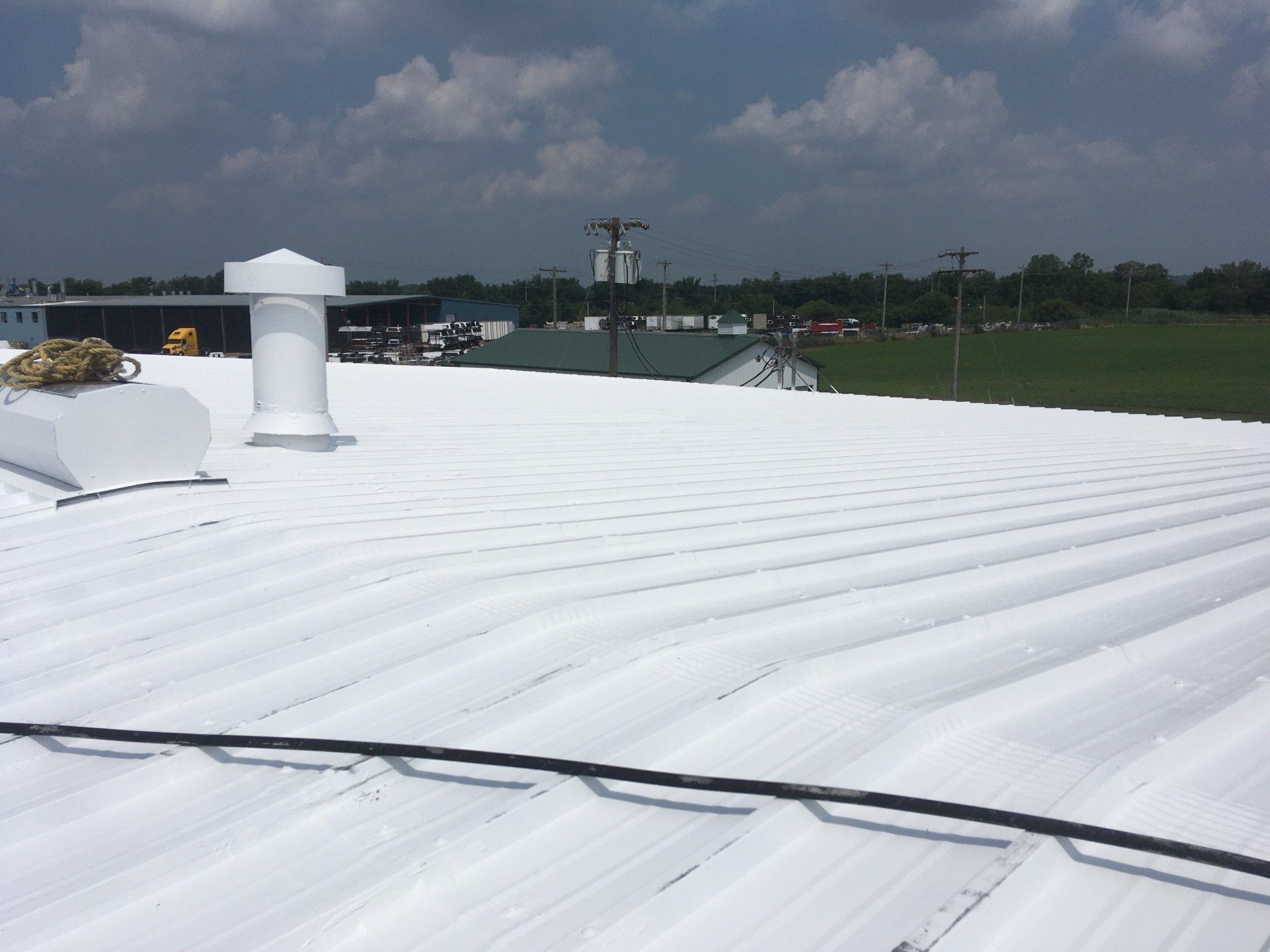 A coated white roof with a chimney on top of it