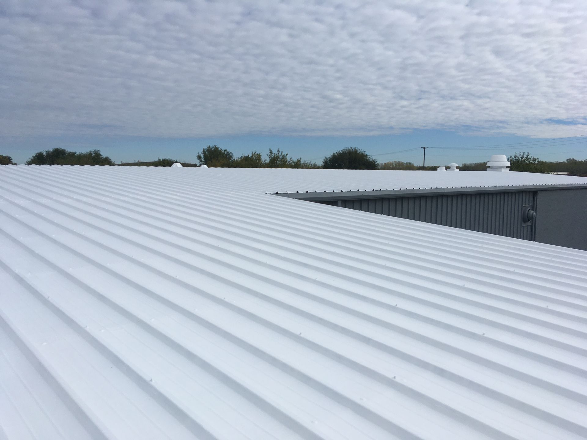 A white roof with a blue sky in the background