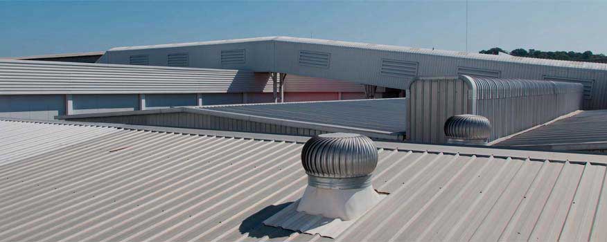 A coated metal roof with a fan on top of it.
