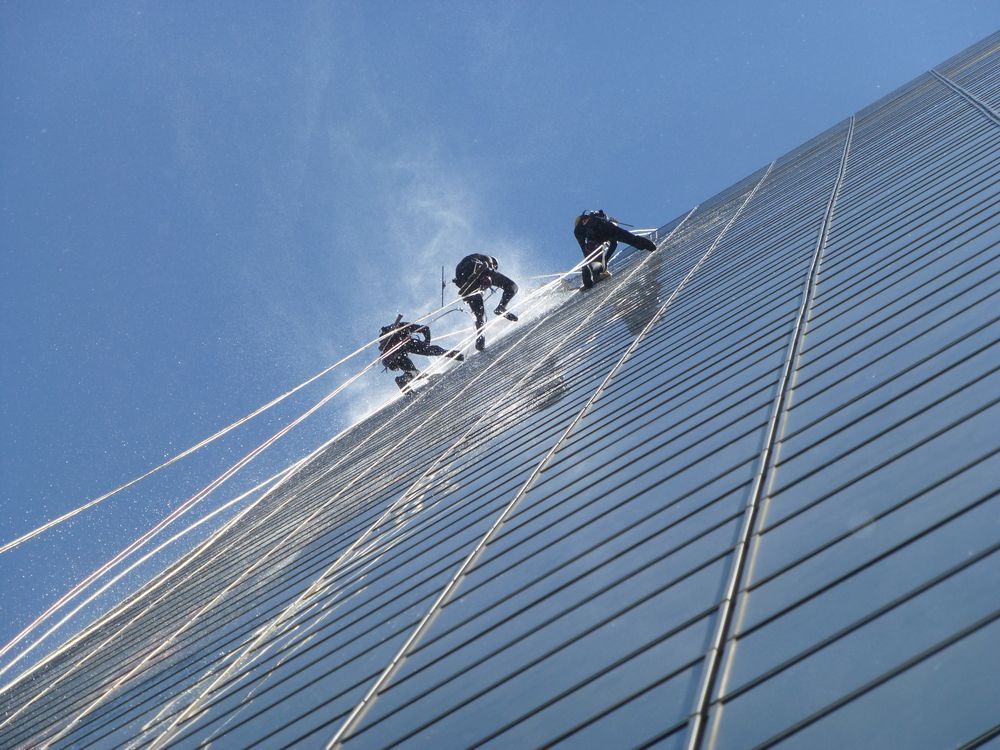 Three Window Washers Descending a Tall, Glass Skyscraper — Crystal Clear In Guyra, NSW