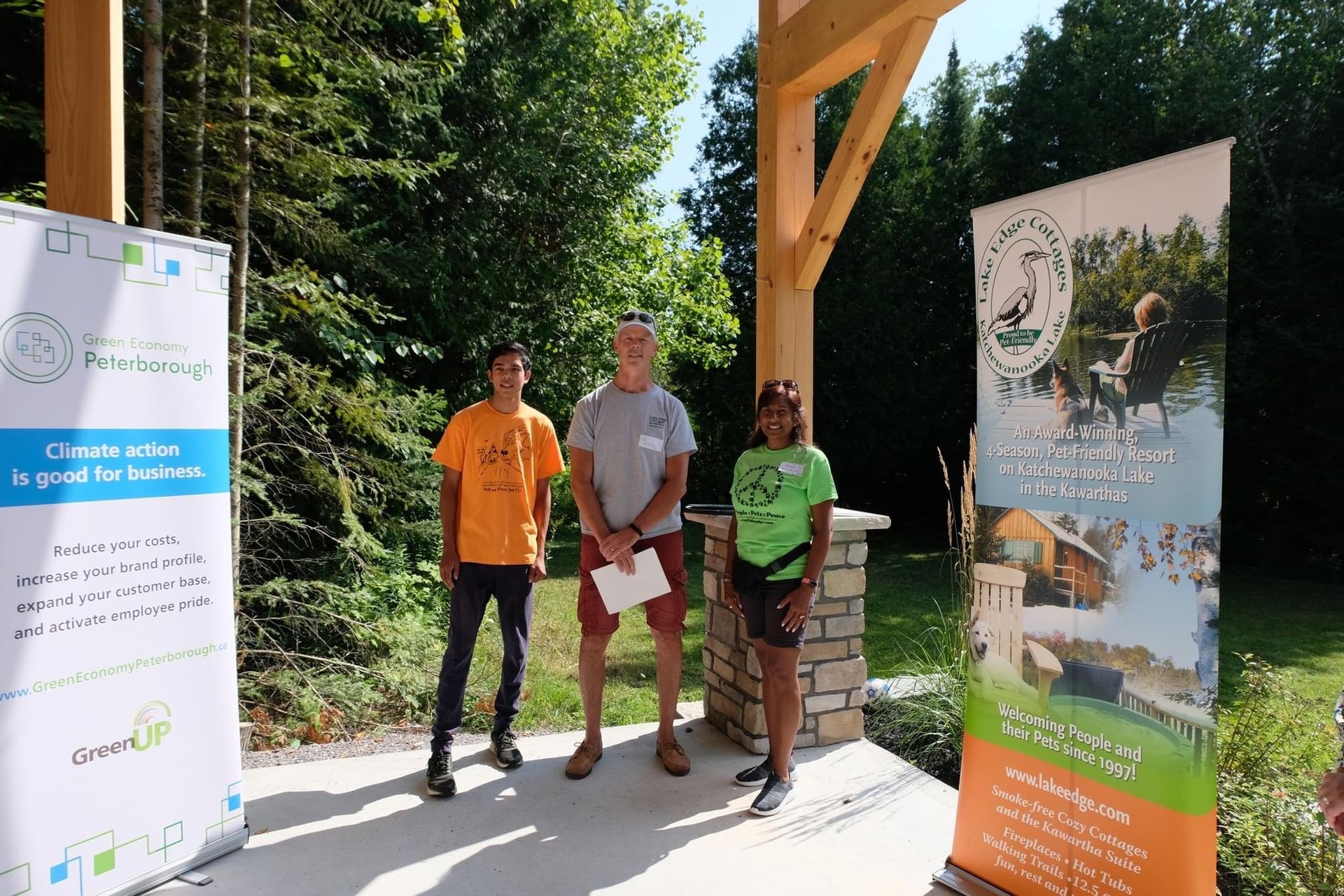 A group of people standing next to each other in front of a sign.
