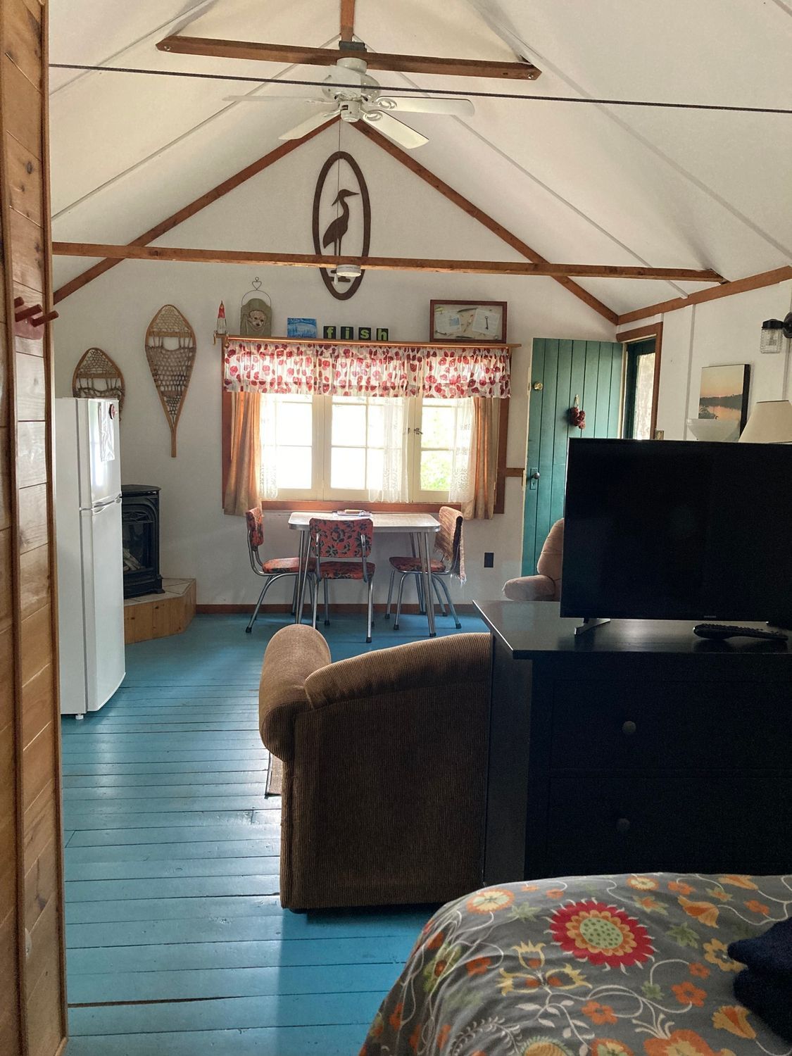 A bedroom with a bed and a television in it