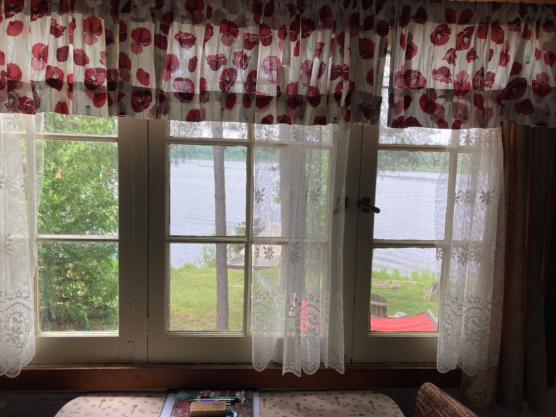 A living room with a view of a lake through a window.