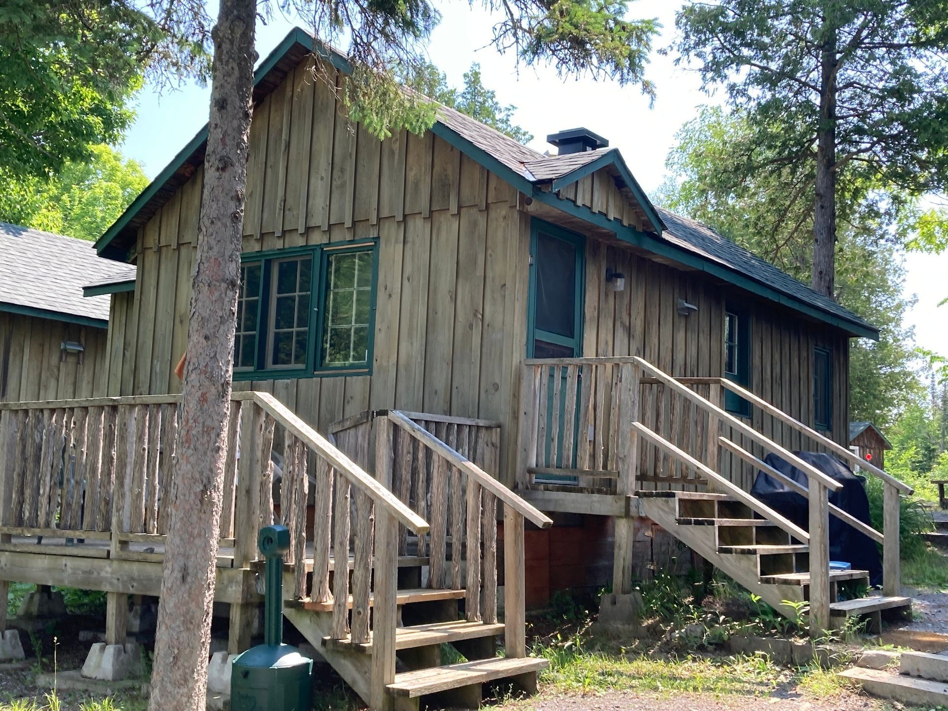 A small wooden house with stairs leading up to it