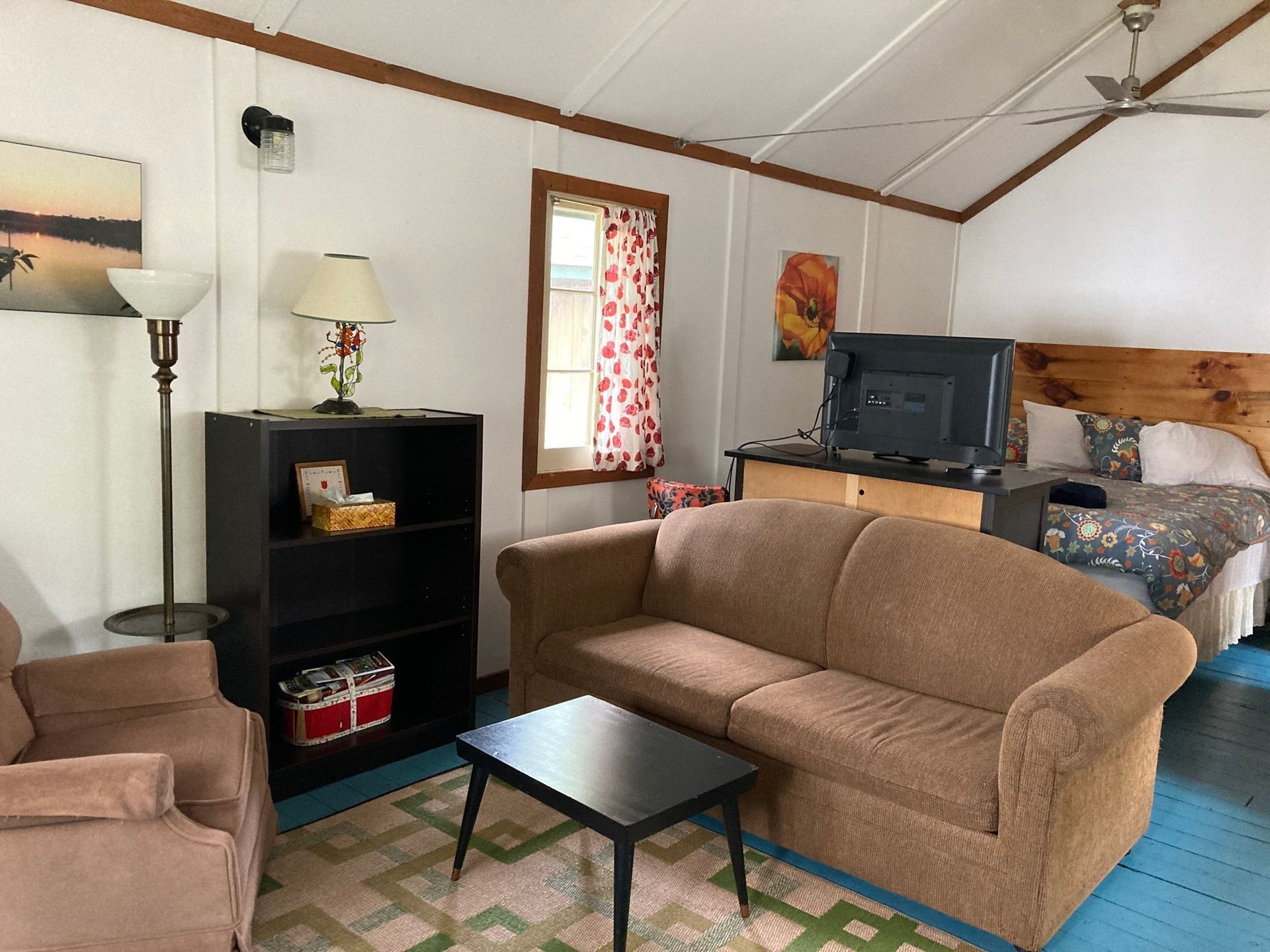 A living room with a couch and two chairs