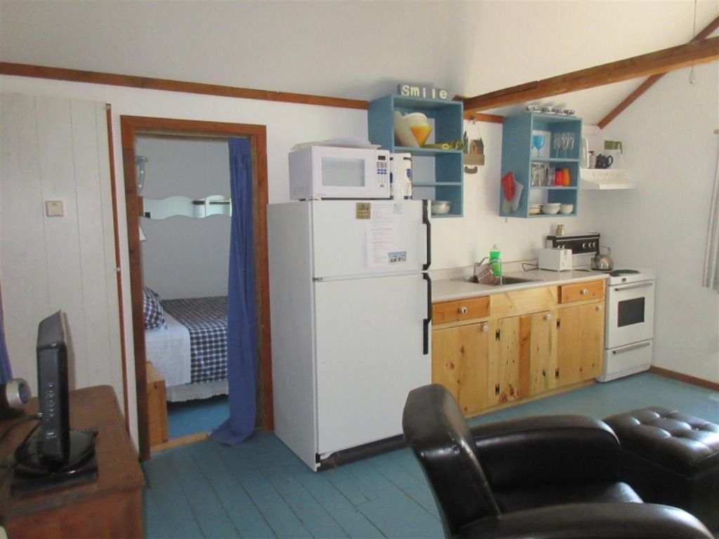A kitchen with a refrigerator and a microwave