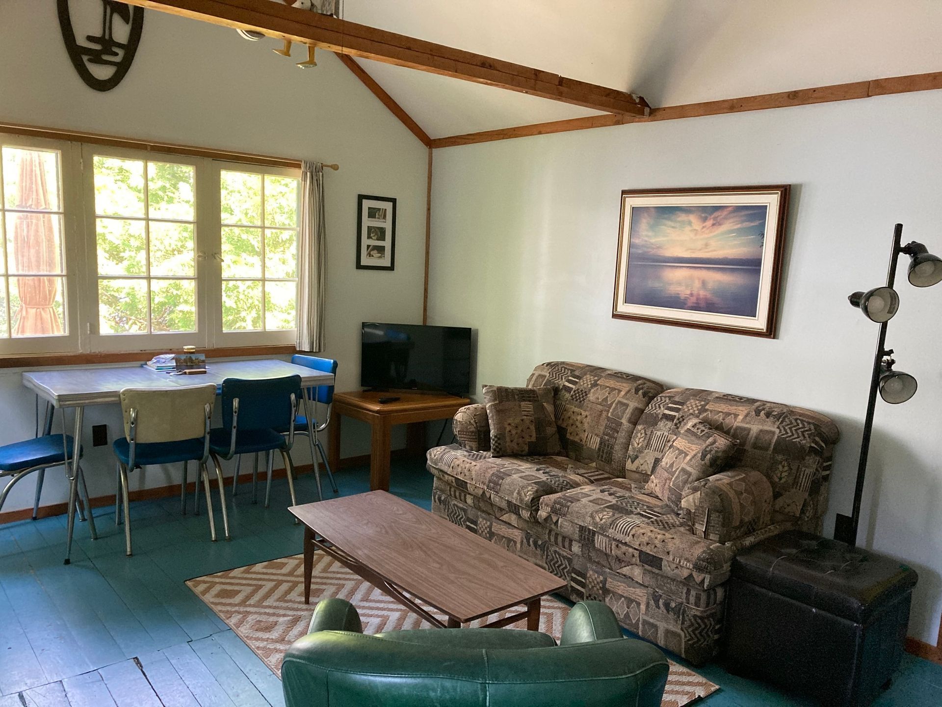 A living room with a couch a table and chairs