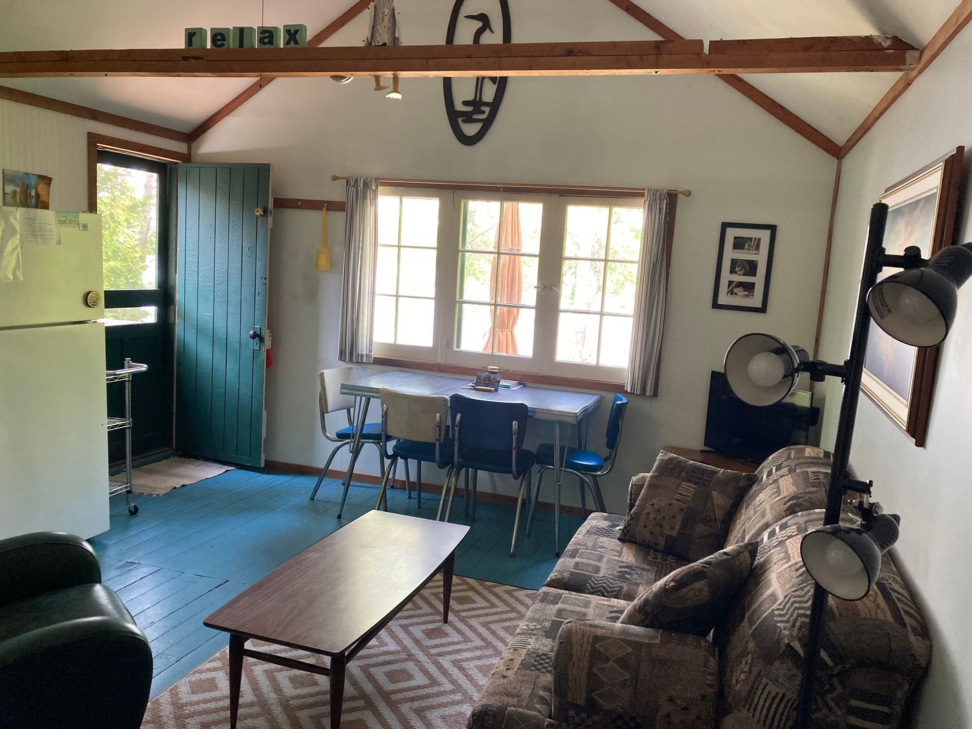 A living room with a couch a table and chairs