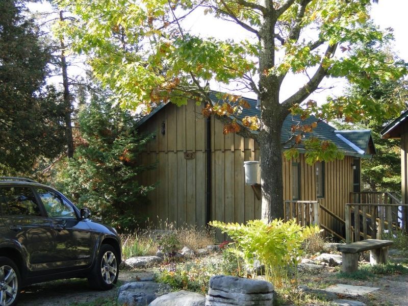 A car is parked in front of a small house