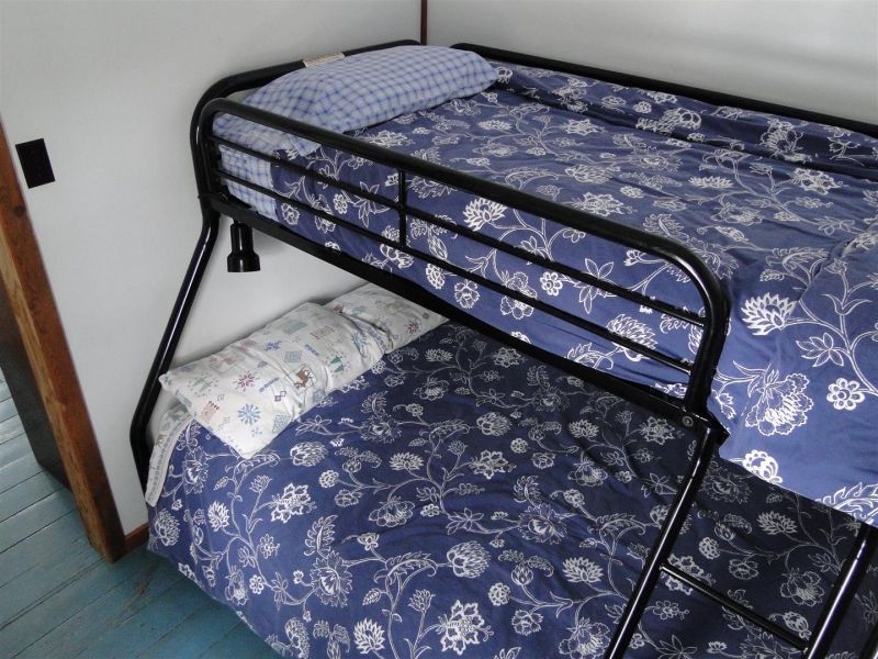 A bunk bed with a blue and white floral comforter