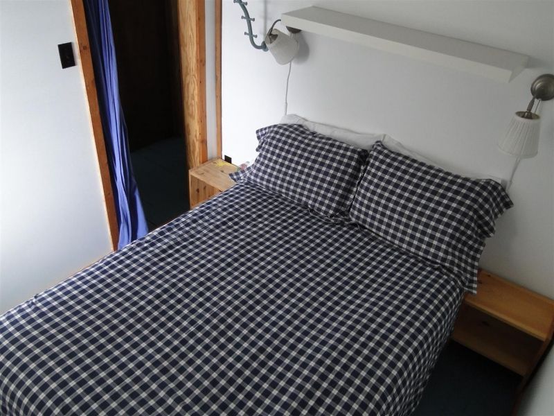A bed with black and white checkered sheets and pillows