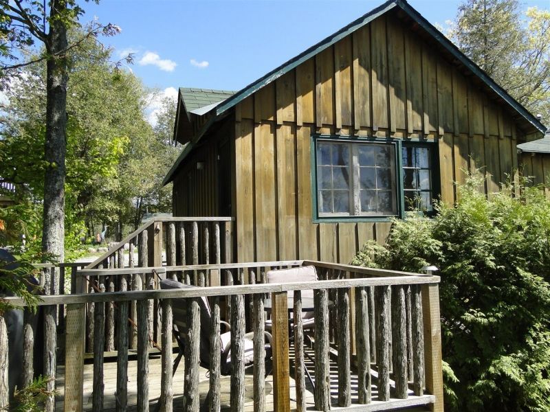 A small house with a wooden deck in front of it