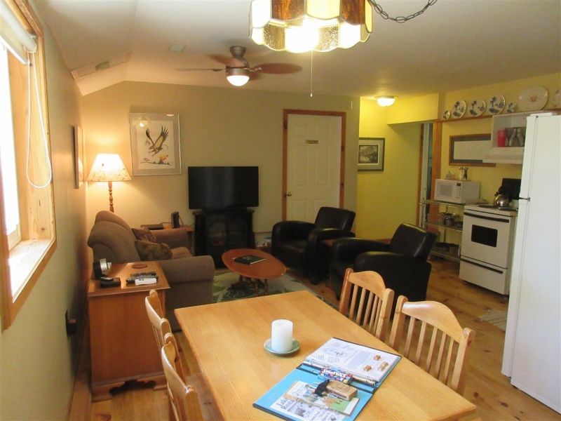 A living room with a dining table and chairs