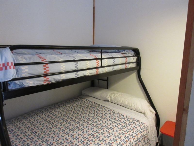 A bunk bed in a corner of a room