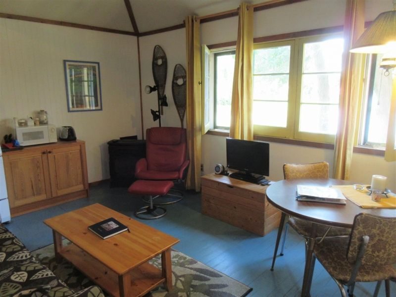 A living room with a table chairs and a television