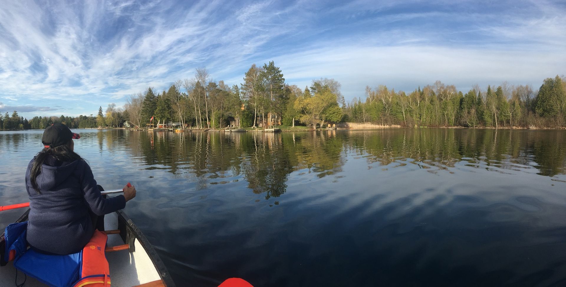 A person is sitting in a kayak on a lake.