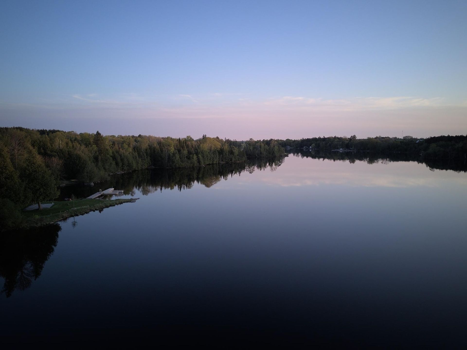 An aerial view of a large body of water surrounded by trees.