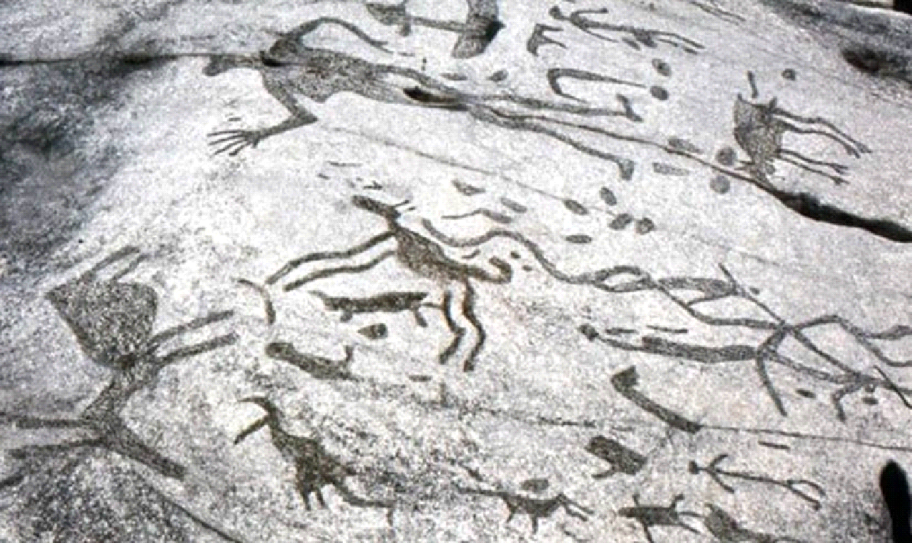 A black and white photo of a rock with drawings on it