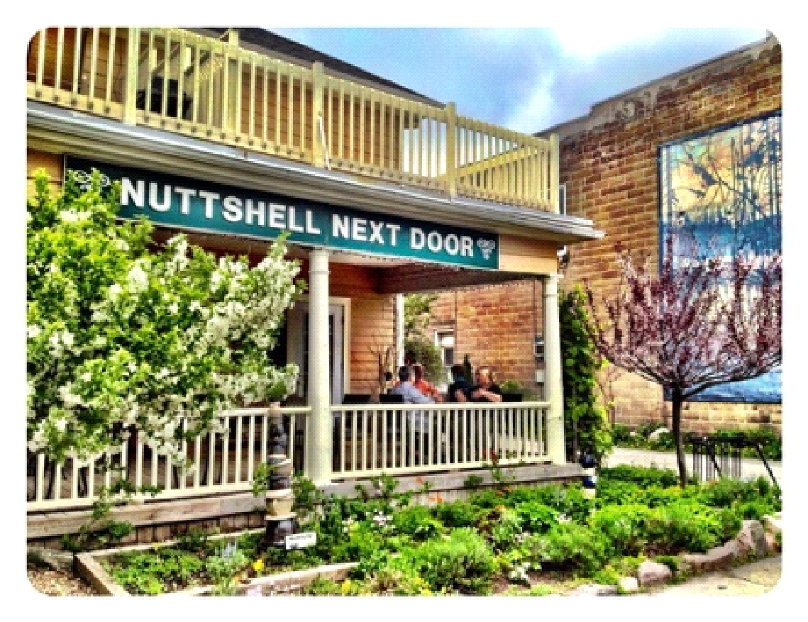 A building with a sign that says nutshell next door
