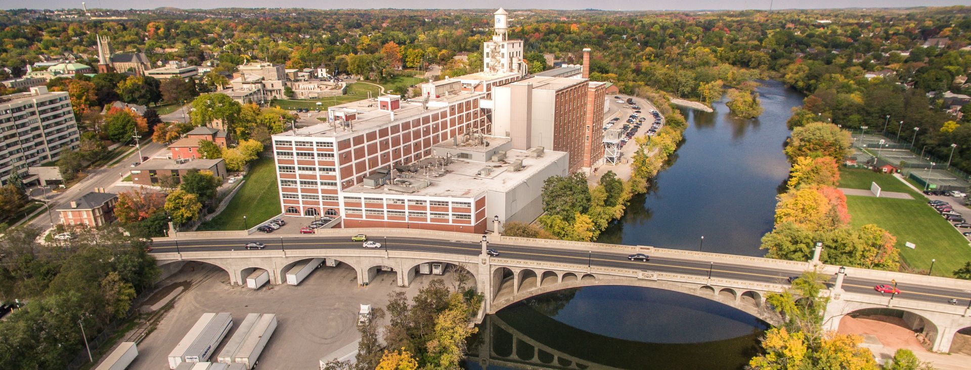 An aerial view of a bridge over a river in a city.