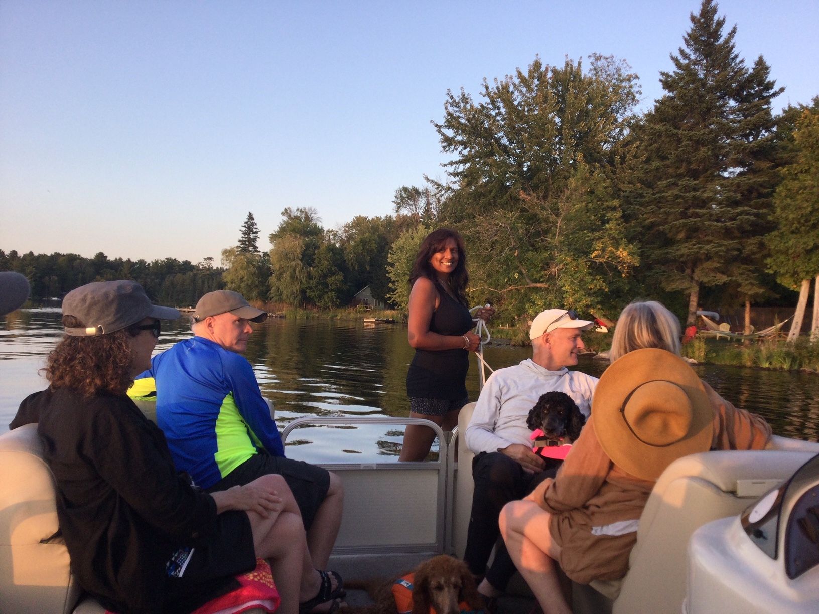 A group of people are sitting on a boat on a lake