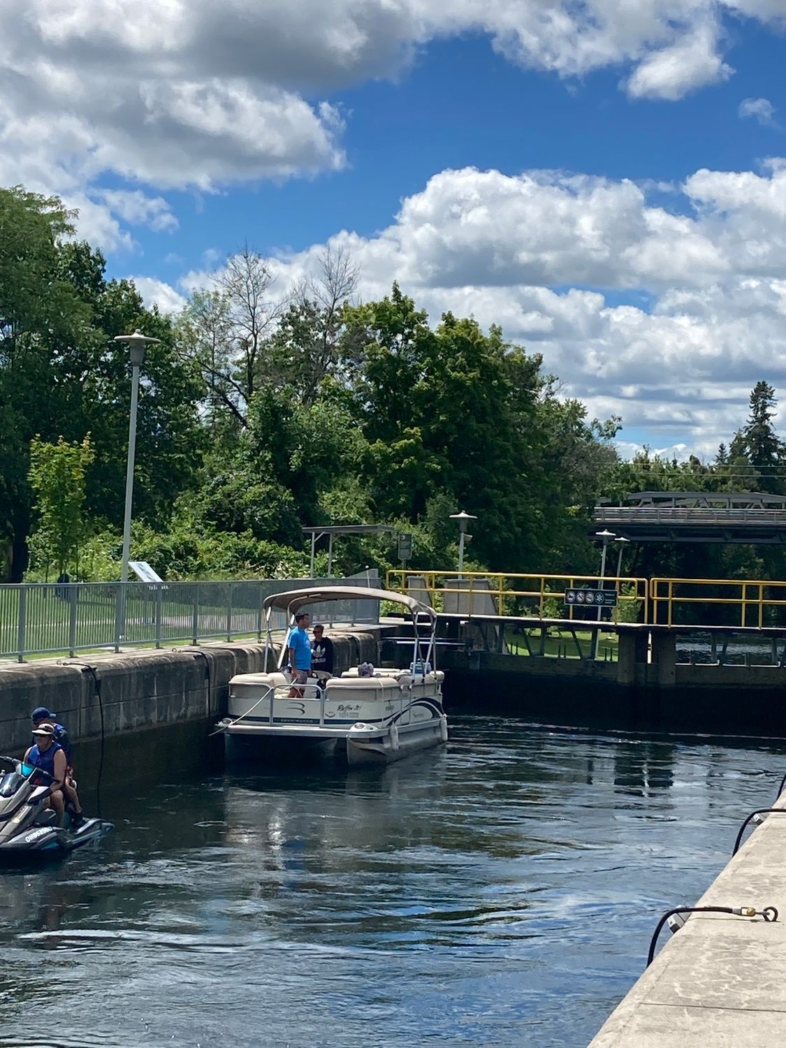 A boat is going through a lock on a river