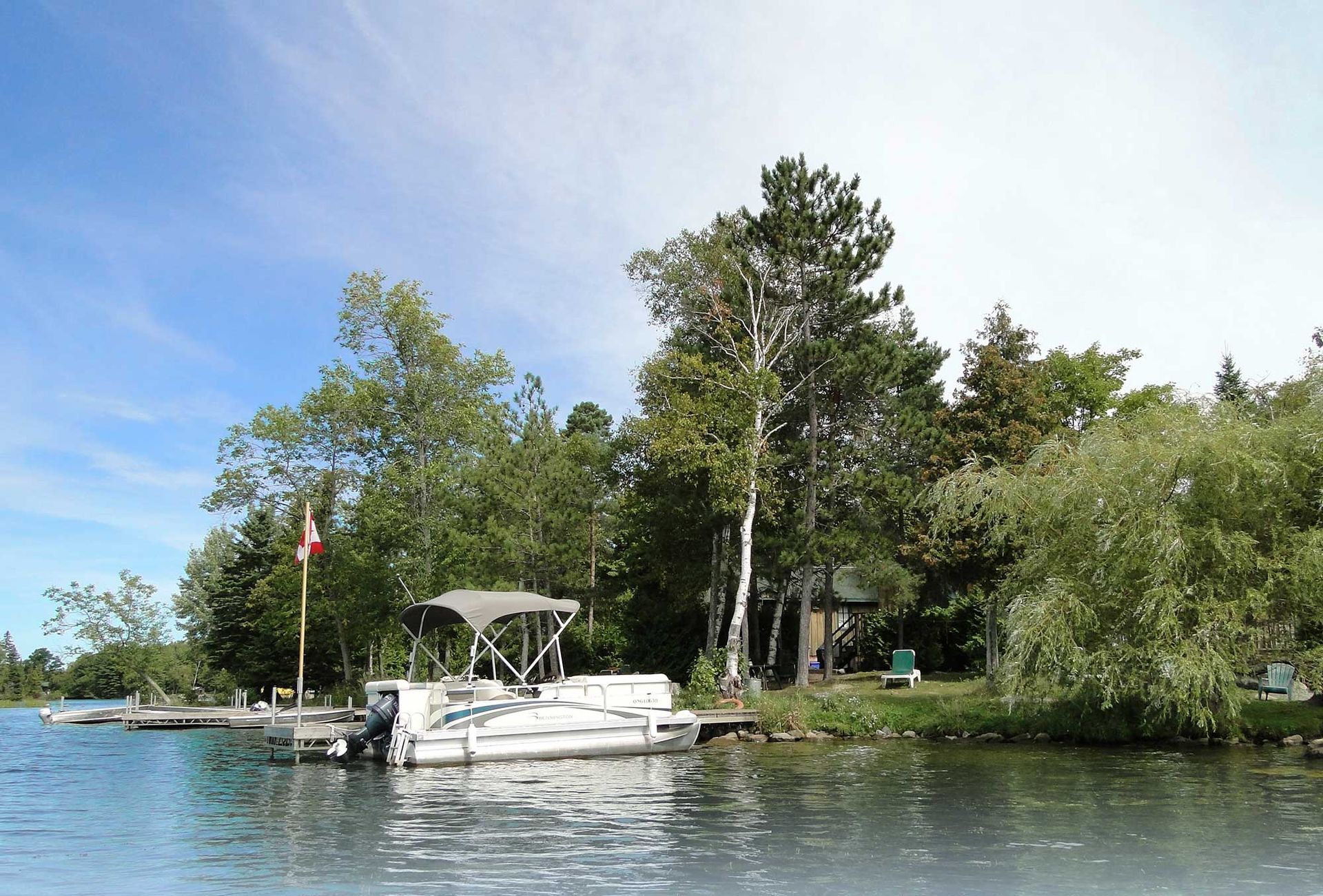 A boat is docked on the shore of a lake