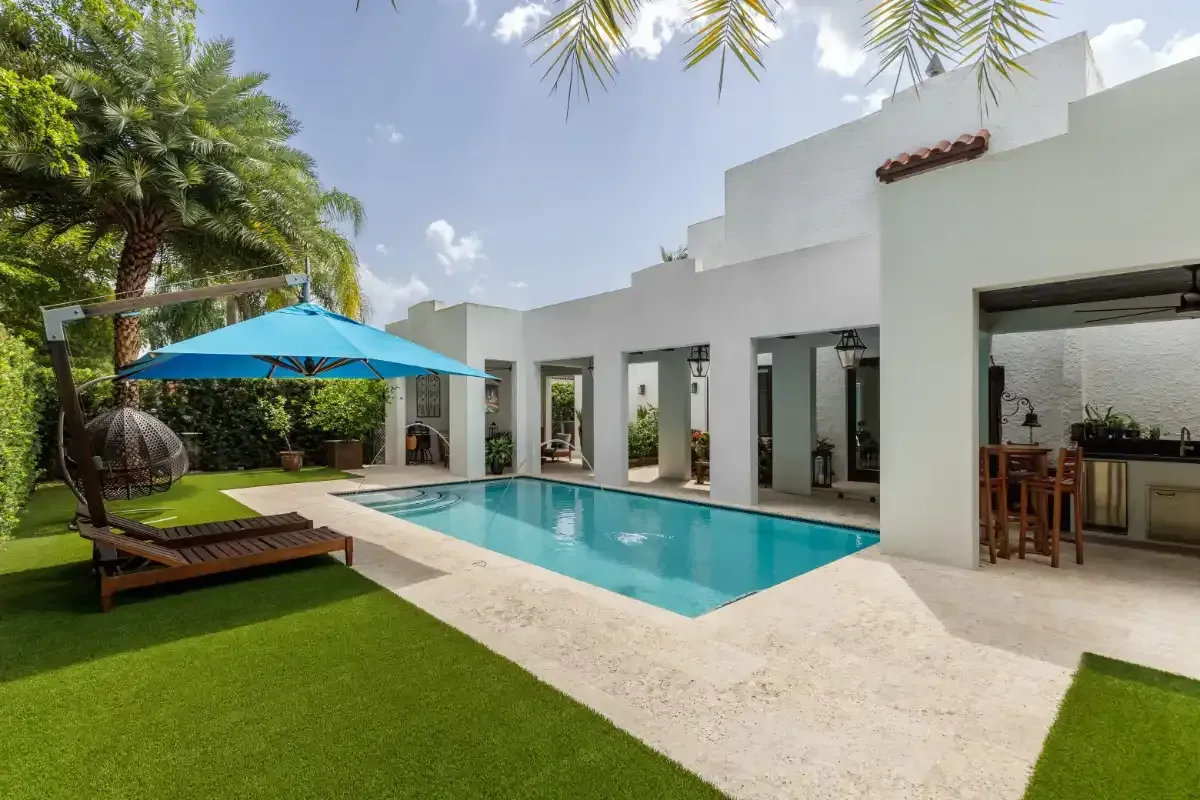 Florida backyard with light concrete deck and artificial turf