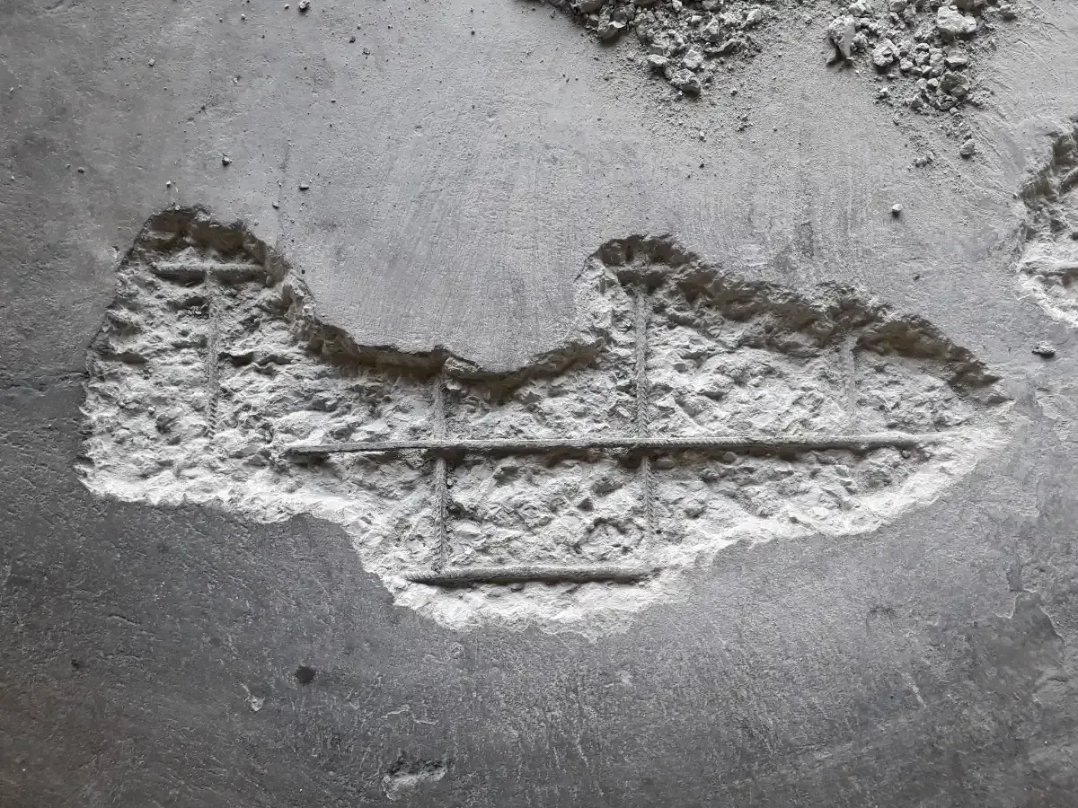 exposed steel rebar in concrete surface