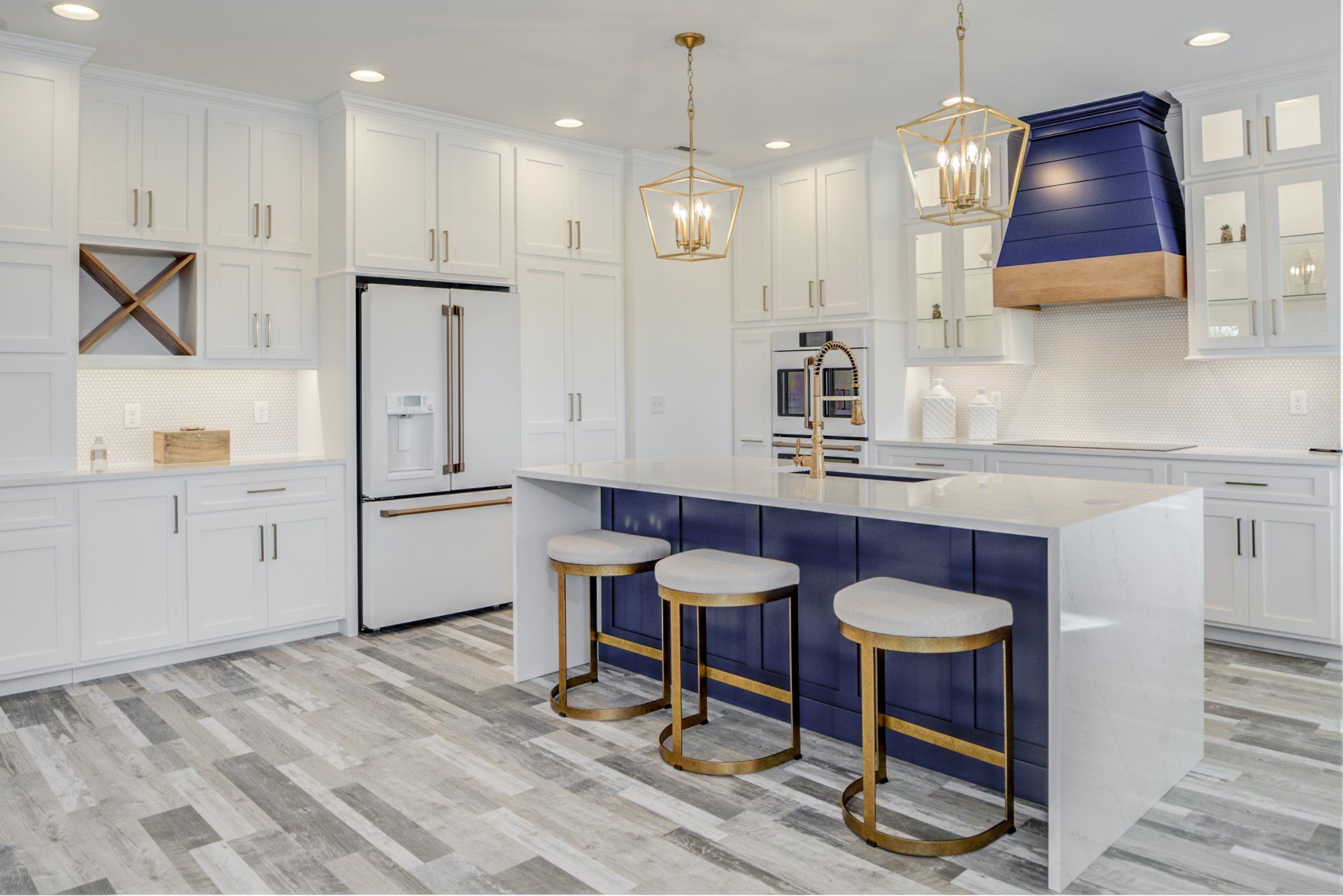 Luxurious kitchen with white cabinets and  blue island | Bay to Beach Builders | Greenwood, DE 19950